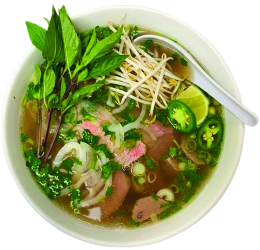 Sliced rare beef phở with fresh herbs, bean sprouts, lime, and jalapeños
